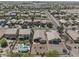 Aerial view of desert neighborhood showing home with pool, patio, and desert landscaping in backyard at 44284 W Buckhorn Trl, Maricopa, AZ 85138