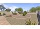 Desert landscaped backyard with gravel and low maintenance plants, including a well at 44284 W Buckhorn Trl, Maricopa, AZ 85138