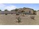 Expansive backyard features desert landscaping and a covered patio area perfect for outdoor living at 44284 W Buckhorn Trl, Maricopa, AZ 85138
