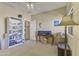 This bedroom features a bookcase, a table, and an exit doorway at 44284 W Buckhorn Trl, Maricopa, AZ 85138