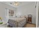 This bedroom features a window, closet, and a ceiling fan at 44284 W Buckhorn Trl, Maricopa, AZ 85138