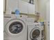 This laundry room features a washer and dryer set with lots of storage at 44284 W Buckhorn Trl, Maricopa, AZ 85138
