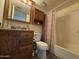 Bathroom features single sink vanity with dark wood and shower at 461 W Holmes Ave # 336, Mesa, AZ 85210