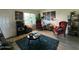 A sun-filled living room featuring modern decor, a teal rug, and wingback chairs at 461 W Holmes Ave # 336, Mesa, AZ 85210