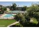 Community pool and tennis courts surrounded by lush landscaping at 461 W Holmes Ave # 336, Mesa, AZ 85210