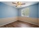 Bedroom featuring vinyl floors, ceiling fan, and natural light at 4744 W Altadena Ave, Glendale, AZ 85304