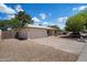 Wide angle view of charming single-story home with spacious driveway and a two-car garage at 4744 W Altadena Ave, Glendale, AZ 85304