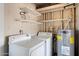 Functional laundry room with washer, dryer, hot water tank, and shelving, providing efficient space at 4744 W Altadena Ave, Glendale, AZ 85304