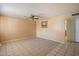 Neutral living room showcasing tiled floors, ceiling fan, and view to kitchen at 4744 W Altadena Ave, Glendale, AZ 85304
