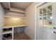 Practical storage room with pegboard wall, workbench, and natural light from the exterior door at 4744 W Altadena Ave, Glendale, AZ 85304