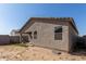 Backyard with a covered patio, a block fence, and lots of natural light at 47859 W Moeller Rd, Maricopa, AZ 85139