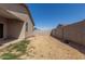 Backyard featuring partial grass, a block fence, and access to the covered patio at 47859 W Moeller Rd, Maricopa, AZ 85139