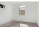 The neutral bedroom features carpet and a window with mount for a tv at 47859 W Moeller Rd, Maricopa, AZ 85139