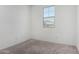 Bright bedroom features neutral carpet, a window, and ample natural light at 47859 W Moeller Rd, Maricopa, AZ 85139