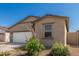 Charming single-level desert home with a tan stucco exterior, a side yard, and drought-resistant landscaping at 47859 W Moeller Rd, Maricopa, AZ 85139