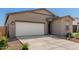 Attractive single-story home featuring a white garage door, a neutral facade, and low-water landscaping at 47859 W Moeller Rd, Maricopa, AZ 85139