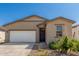 Inviting single-level home showcasing a two-car garage, a dark front door, and desert-style rock landscaping at 47859 W Moeller Rd, Maricopa, AZ 85139