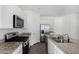 Modern kitchen with stainless steel appliances, granite countertops and dark wooden flooring at 47859 W Moeller Rd, Maricopa, AZ 85139
