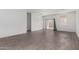 Spacious living area featuring wood-look tile flooring, a sliding glass door, and plenty of room to entertain at 47859 W Moeller Rd, Maricopa, AZ 85139