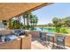 Charming balcony featuring outdoor seating, with views of the pond, palm trees, and lush greenery at 5102 N 31St Pl # 436, Phoenix, AZ 85016