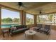 Covered outdoor patio with comfortable seating and scenic views of the lush landscape and lake at 5102 N 31St Pl # 436, Phoenix, AZ 85016