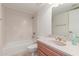 Cozy bathroom with tiled walls, shower-tub combo, and vanity with gold fixtures at 5102 N 31St Pl # 436, Phoenix, AZ 85016
