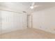 Bright bedroom with plush carpet, ceiling fan, and closet for ample storage at 5102 N 31St Pl # 436, Phoenix, AZ 85016