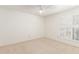 Bright bedroom offers a fan, neutral carpet, and shuttered windows at 5102 N 31St Pl # 436, Phoenix, AZ 85016