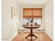 Dining area with a round table, chairs, window with woven shade and red tiled flooring at 5102 N 31St Pl # 436, Phoenix, AZ 85016