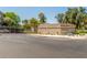 View of the Biltmore Terrace entrance with a secure gate and lush landscaping at 5102 N 31St Pl # 436, Phoenix, AZ 85016