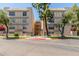 Condo building surrounded by green grass, trees, and flowers at 5102 N 31St Pl # 436, Phoenix, AZ 85016