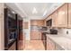 Bright kitchen featuring wood cabinets, countertops, and stainless steel appliances, complemented by tiled flooring at 5102 N 31St Pl # 436, Phoenix, AZ 85016