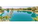 Expansive lake view with calm, blue waters reflecting the surrounding trees and sky at 5102 N 31St Pl # 436, Phoenix, AZ 85016
