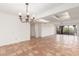 Spacious and bright living room with terracotta tile floors, chandelier, and sliding glass doors at 5102 N 31St Pl # 436, Phoenix, AZ 85016