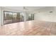Bright living room boasts terracotta tile flooring, mirrored wall, ceiling fan, and sliding glass doors to balcony at 5102 N 31St Pl # 436, Phoenix, AZ 85016