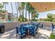 Relaxing patio with a blue dining set and cushioned seating, perfect for outdoor gatherings at 5102 N 31St Pl # 436, Phoenix, AZ 85016