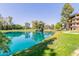 Scenic view of the pond with lush greenery and an apartment building on a clear day at 5102 N 31St Pl # 436, Phoenix, AZ 85016