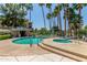 Inviting community pool and spa area surrounded by lush landscaping and palm trees at 5102 N 31St Pl # 436, Phoenix, AZ 85016