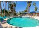 Inviting community pool area with lounge chairs, surrounded by palm trees, perfect for relaxation at 5102 N 31St Pl # 436, Phoenix, AZ 85016
