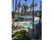 Community pool area with blue tiled roofing, a hot tub, and mature landscaping at 5102 N 31St Pl # 436, Phoenix, AZ 85016