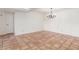 Open room with a decorative light fixture, and red tiled floors, freshly painted at 5102 N 31St Pl # 436, Phoenix, AZ 85016