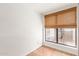 Small room featuring red tiled floor, a window with woven shade, and white walls at 5102 N 31St Pl # 436, Phoenix, AZ 85016
