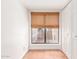 Small room featuring red tiled floor, a window with woven shade, and a closet with white doors at 5102 N 31St Pl # 436, Phoenix, AZ 85016