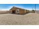 Wide shot of the backyard revealing minimal landscaping, with block walls and a covered patio at 531 S 198Th Ave, Buckeye, AZ 85326