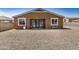 The backyard has a patio and gravel landscaping surrounding the house, great for outdoor enjoyment at 531 S 198Th Ave, Buckeye, AZ 85326