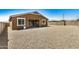 Rear exterior showcasing sliding glass doors to the patio and low maintenance landscaping, ideal for relaxing at 531 S 198Th Ave, Buckeye, AZ 85326