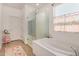 Inviting bathroom features a soaking tub, glass-enclosed shower, and bright natural light at 531 S 198Th Ave, Buckeye, AZ 85326