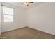 Carpeted bedroom featuring bright light fixture and window at 531 S 198Th Ave, Buckeye, AZ 85326