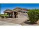 Attractive single-story home with desert landscaping, a brick-paver driveway, and a two-car garage on a clear day at 531 S 198Th Ave, Buckeye, AZ 85326