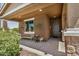 Inviting covered front porch with stone columns, seating, and decorative touches, enhancing curb appeal at 531 S 198Th Ave, Buckeye, AZ 85326